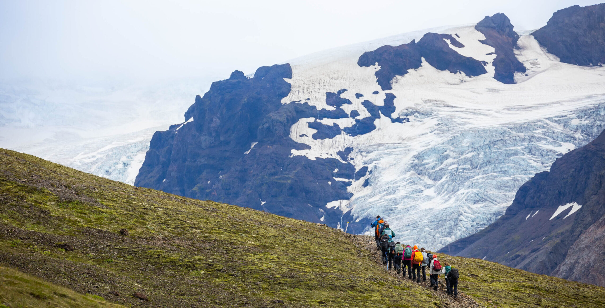 Group hiking above valleys