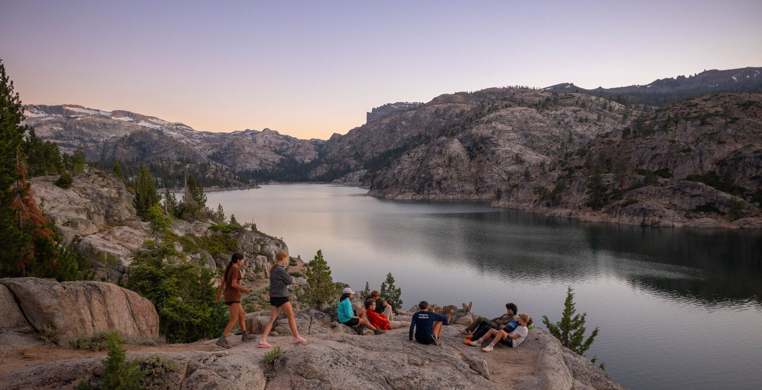 Students bond after a day of hiking overlooking a beautiful lake