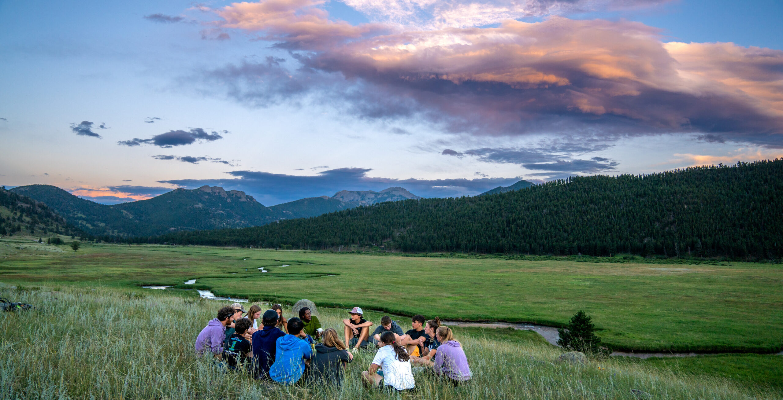 Groups reflect on their days together as they watch a sunset.