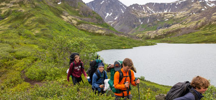 teens on a hiking summer camp trip in the mountains