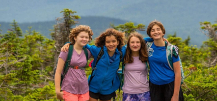 group of kids smiling together at youth adventure camp