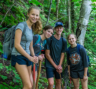 Youth hiking together at Overland outdoor adventure camp