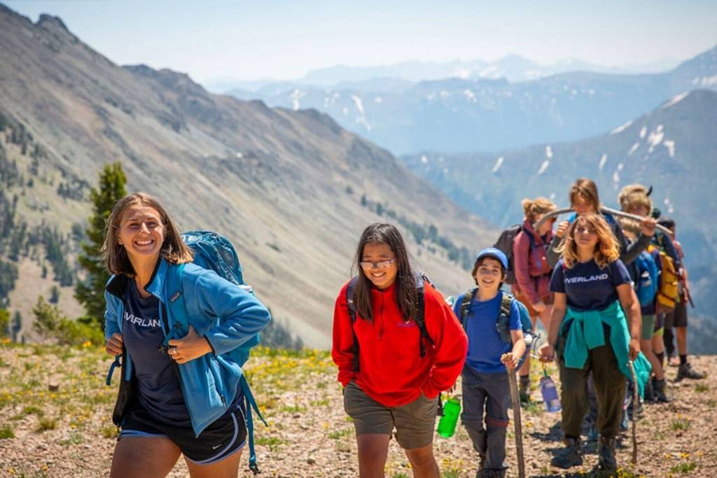 Campers hiking through mountain trails and creating lasting memories on an adventure trip.