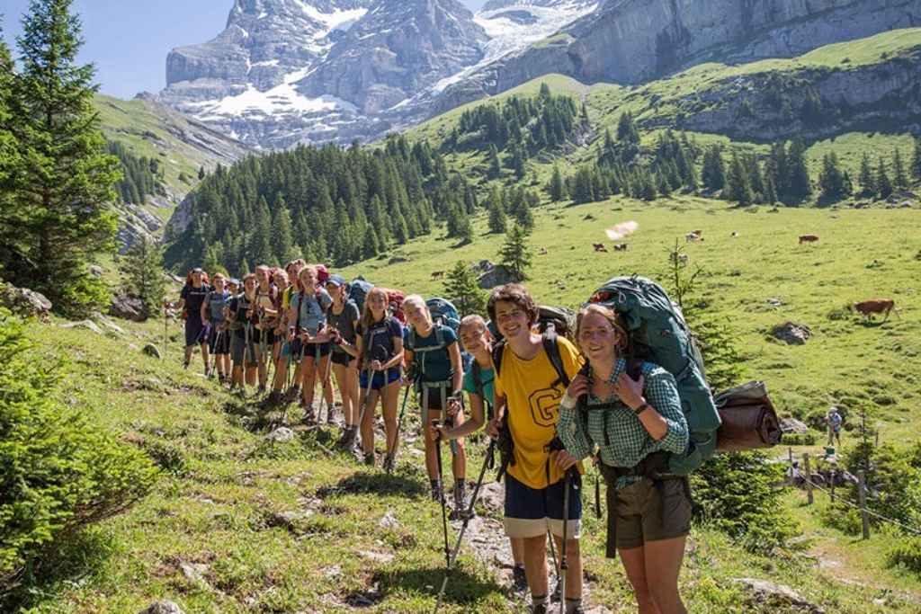 Campers exploring alpine trails on a backpacking adventure in the mountains.