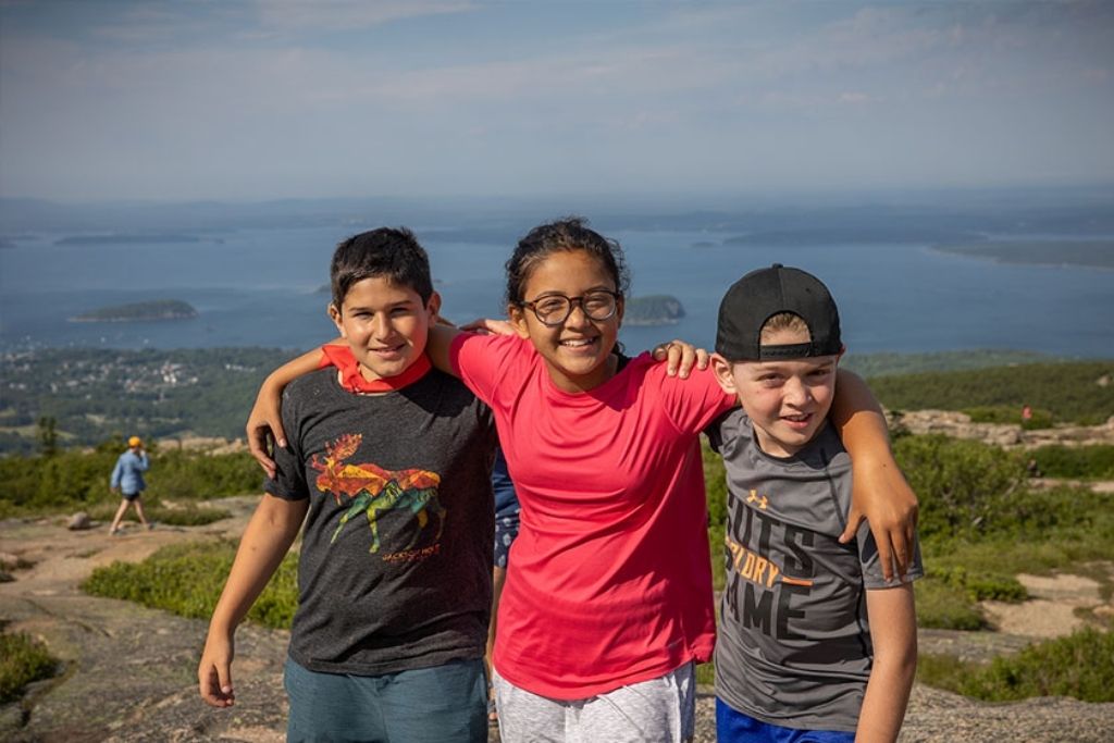 Camp friends celebrating growth and confidence during a memorable mountain adventure.