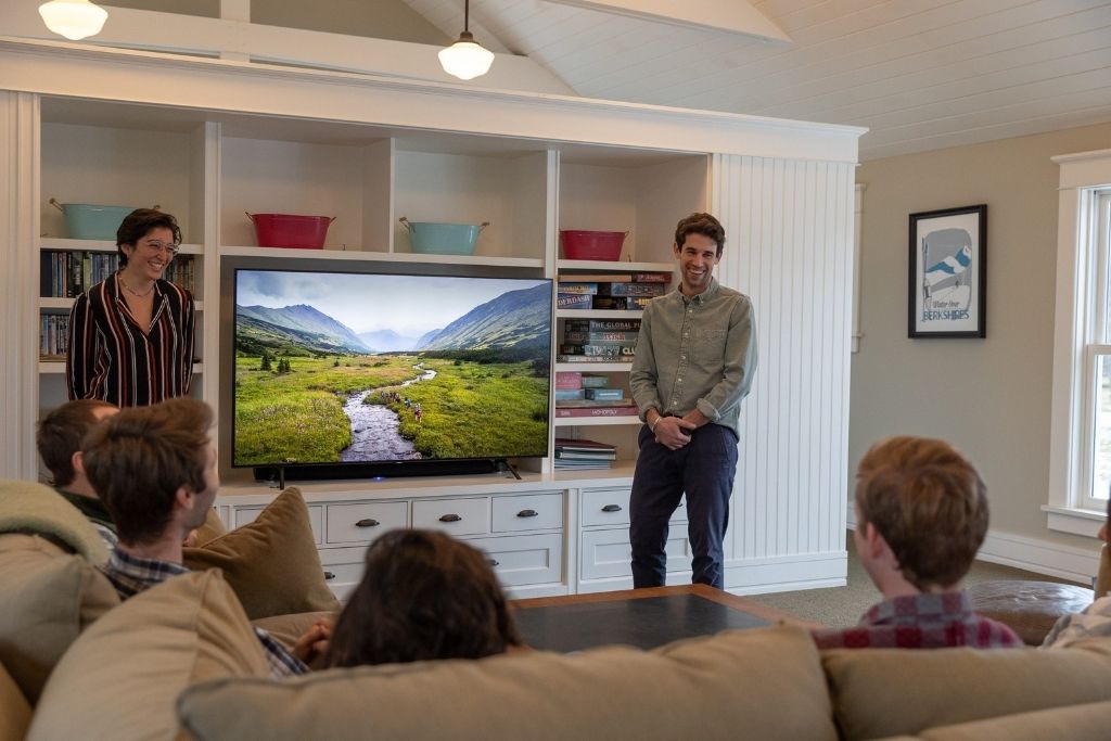 Overland leaders guiding campers through an adventure trip presentation
