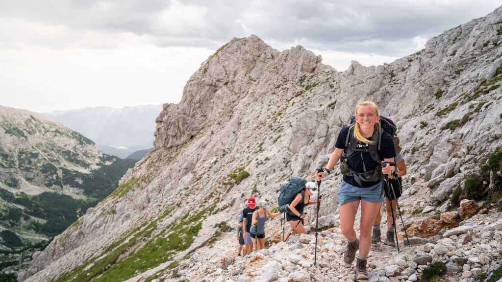 Teens hiking a rocky mountain trail during the Eastern Alps Expedition